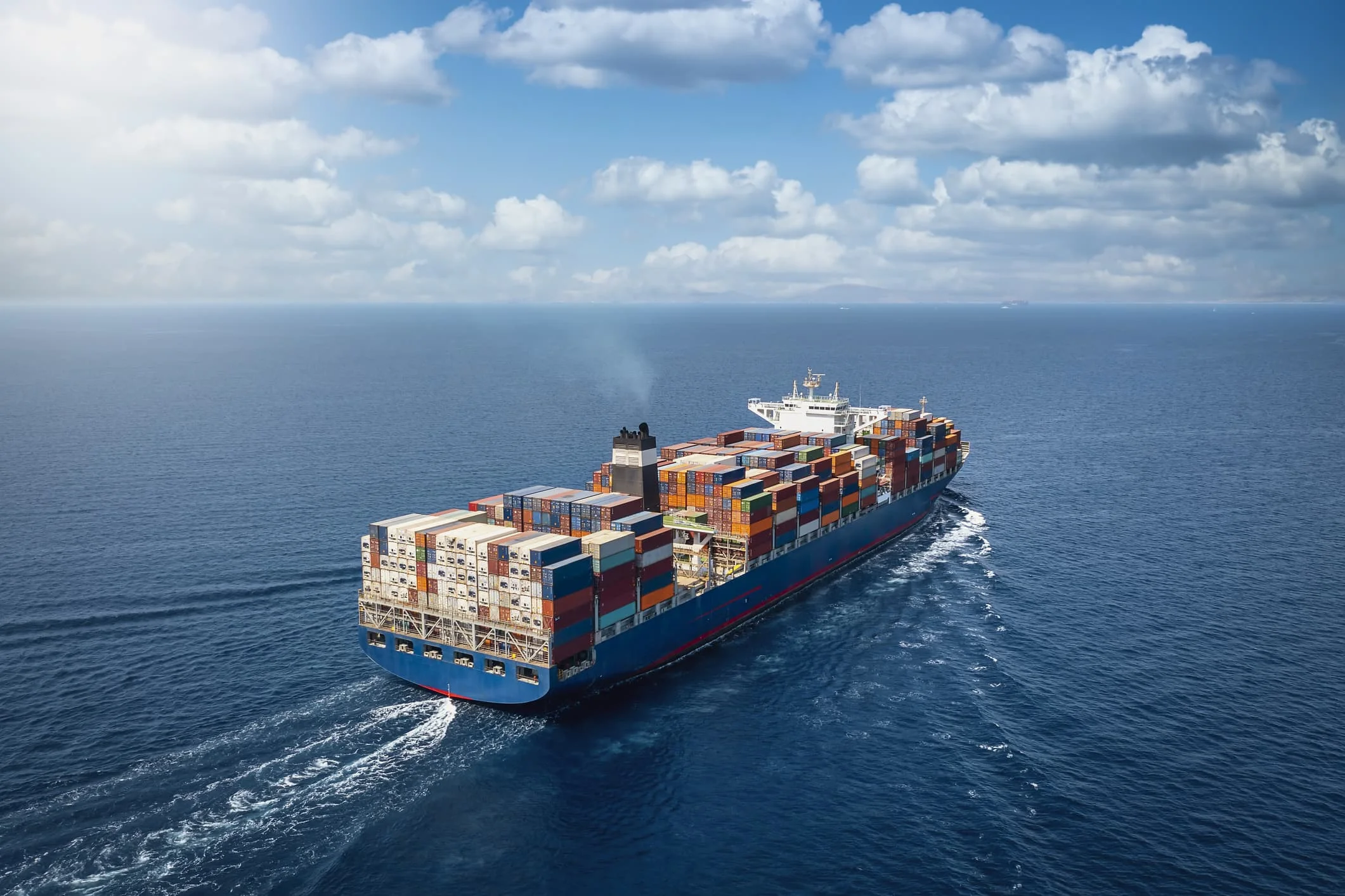 Aerial view of a loaded container ship at sea